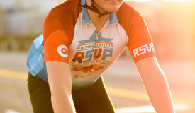 Bicyclist riding in warm weather.